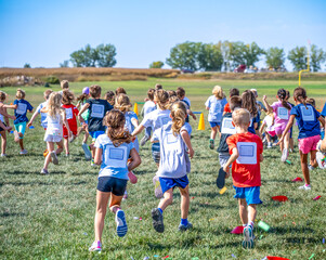 Group of elementary school age children running forward during a fundraising activity. 
