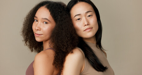 Women, friends and face for skincare, beauty or cosmetics with diversity on a brown studio...