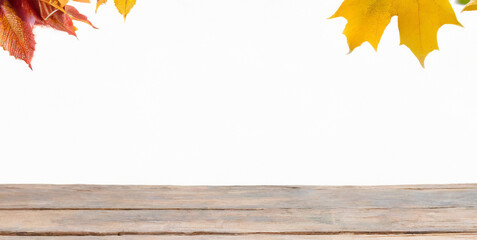 Naklejka na ściany i meble autumn falling leaves and wooden table 