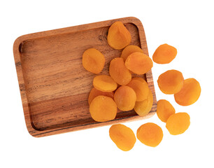 dried apricots on wooden plate isolated on white background with clipping path, top view, flat lay, concept of healthy breakfast