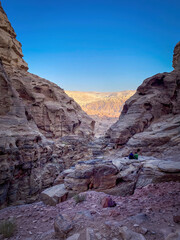People sitting along Ad-Deir Trail Monastery Route in the historic and archaeological city of Petra, Jordan