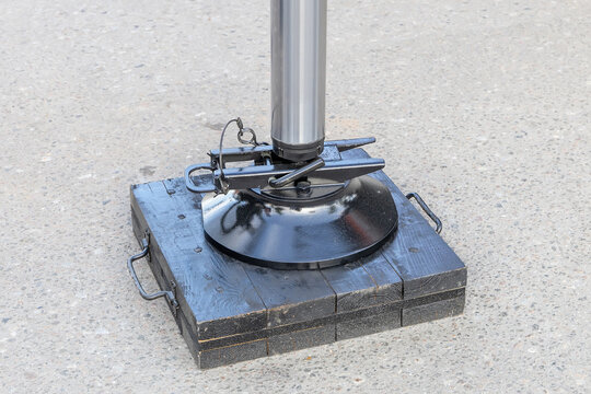 New crane outrigger on a wooden pad. Crane outrigger pad. Stability and safety of wheeled vehicles during lifting operations