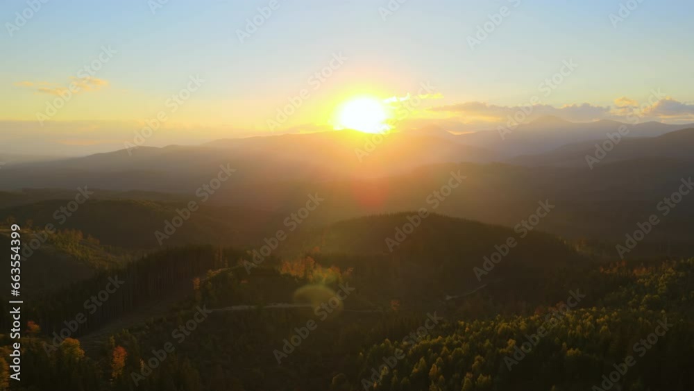 Wall mural Beautiful panoramic mountain landscape with hazy peaks and foggy valley at sunset - Wall murals