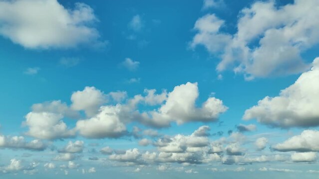 Bright landscape of blue sky with flying white clouds. Colorful summer skyscape
