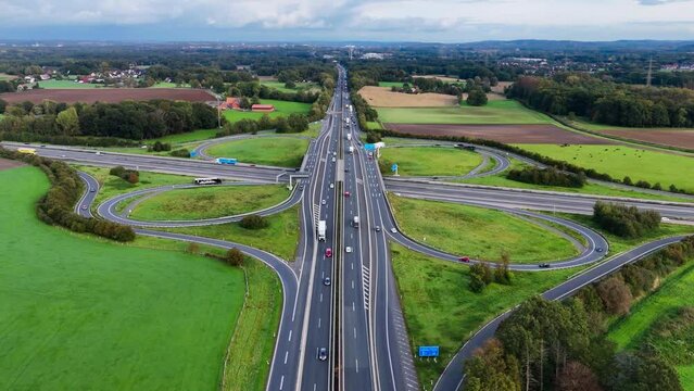 Aerial drone view road junction. Clover roundabout view from above. Car traffic on autobahn Germany. High quality 4k footage