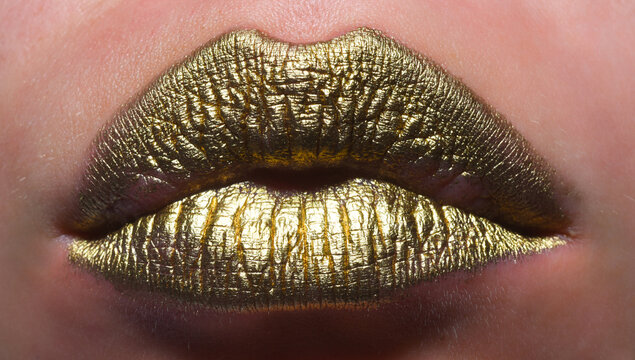 Gold lips, golden lipgloss on sexy lips, metallic mouth. Beauty woman mouth. Sexy girl golden lips, gold mouth. Glowing gold skin and gild lips. Metallic shine golden lip gloss.