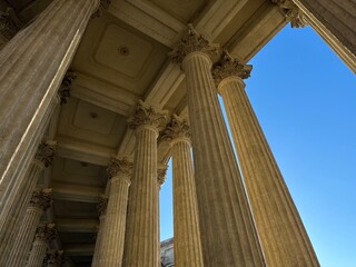 Fototapeta premium antique columns of the cathedral against the blue sky - architecture stock photo