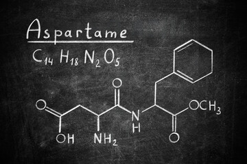 Formula of aspartame (chemical and structural) written on blackboard. Sugar substitute
