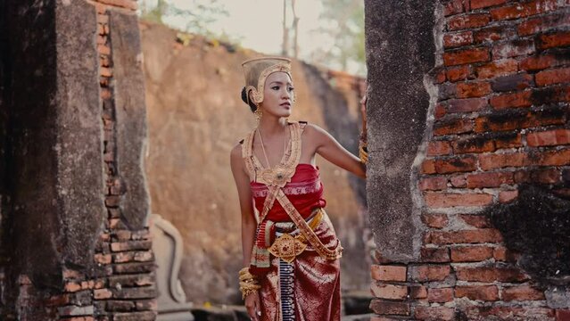 Woman In Chut Thai Posing Near Brick Wall