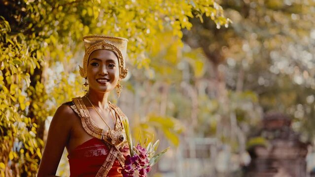 Lady Wearing Chut Thai Holding A Flower