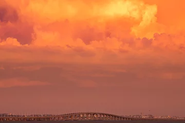 Photo sur Plexiglas Pont Vasco da Gama Dramatic sunset sky with clouds over The Vasco da Gama Bridge in Lisbon, Portugal.