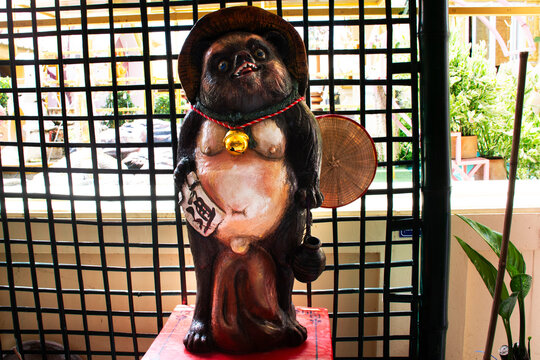 Animal fetish toys and figurine japanese raccoon dog or Tanuki  amulets for thai travelers people travel visit and blessing wish luck at Wat Khao Din Temple on October 7, 2023 in Suphan Buri, Thailand