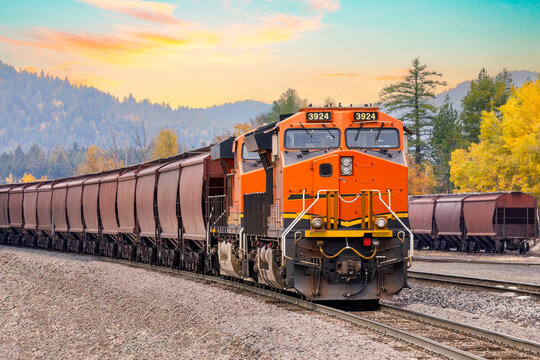 freight train in autumn with a beautiful sunset sky close to Whitefish, Montana