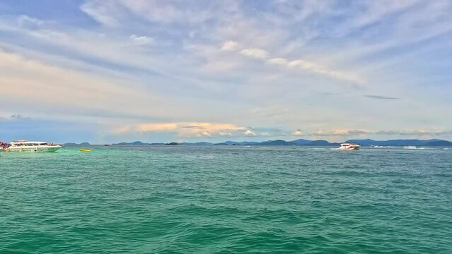 Phi Phi island off the coast of phuket thailand. Phi phi island is famous for turquoise clear blue waters teaming with Corel reef fish white soft sand and lush green trees.