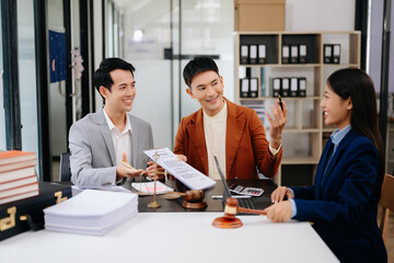 Asian business team and lawyers discussing contract papers sitting at the table. Concepts of law, advice, legal services. at modern office