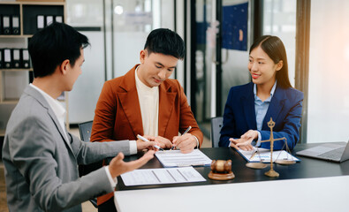 Business people compassionately holding hands and discussing contract papers with laptop and tabletat office room..
