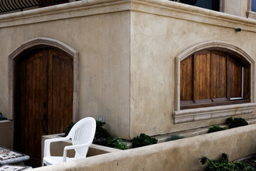 patio and brown wall with wooden doors