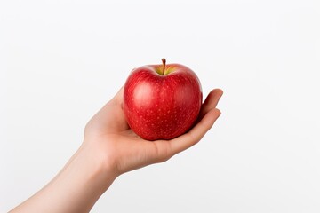 Red apple on human hand isolated on white background