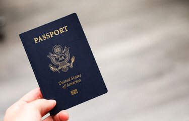 U.S. passport on a dark background, symbolizing travel, identity, citizenship, and international journeys, with patriotic colors and security features