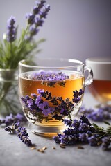 Fresh delicious tea with lavender and lavender flowers on gray stone table, glass