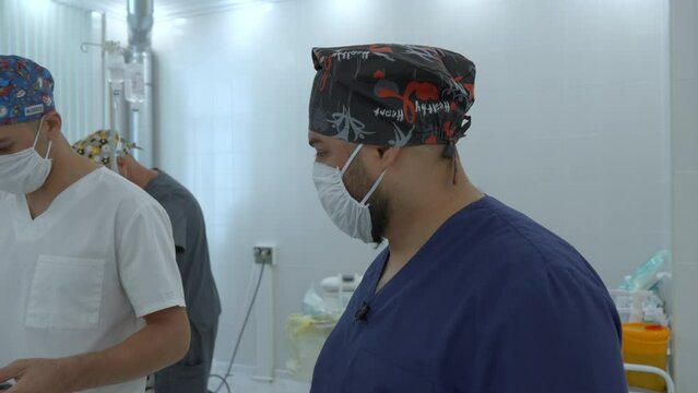 Neurosurgeon and anesthesiologist communicate before the procedure. Action. Concept of healthcare.