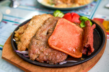 A delicious and tempting sizzling steak, chicken, and pork chop in a Hong Kong-style tea restaurant