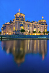 The imposing Reichstag, the german parliament building, at the river Spree at twilight