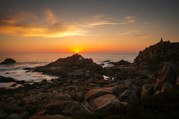 Obraz premium Sunset over the ocean. Beautiful orange sky landscape at the Atlantic Ocean, view from Porto, Portugal. Amazing sea view with rocks and waves.