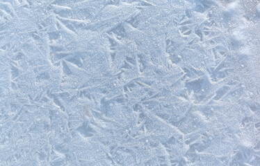 Obraz premium White abstract cold natural texture of icy sea shore on cold day. Winter background of small ice crystals on frozen water surface. Empty space for text. Top view, flat lay, copy space, mockup, blank