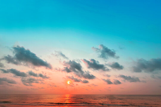 Sunrise horizon cool sea background on horizon tropical sandy beach; relaxing outdoors vacation	