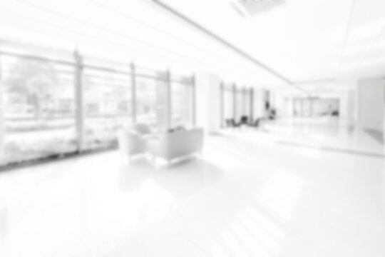 Blur background with glass door inside building gray tone. interior lobby room at sofa in hotel.