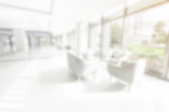 Blur background with glass door inside building gray tone. interior lobby room at sofa in hotel.