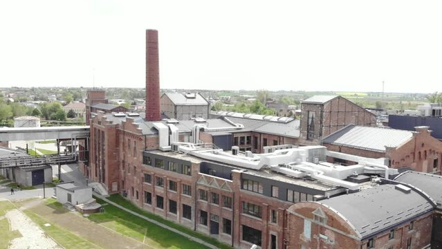 Aerial shot of the Żnin Arche Hotel inside old sugar factory in Poland. The tall chimney of the factory is a famous landmark, rising above the surrounding landscape
