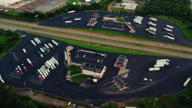 orbiting aerial of Service Plaza in Elkhart Indiana USA. Truck rest stop for semi truck and trailers. CDL drivers can fuel up, Rest stop for any traveler, can shower and eat. Indiana Toll Road I-80
