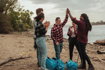 Lovely volunteers doing high fives after collecting garbage