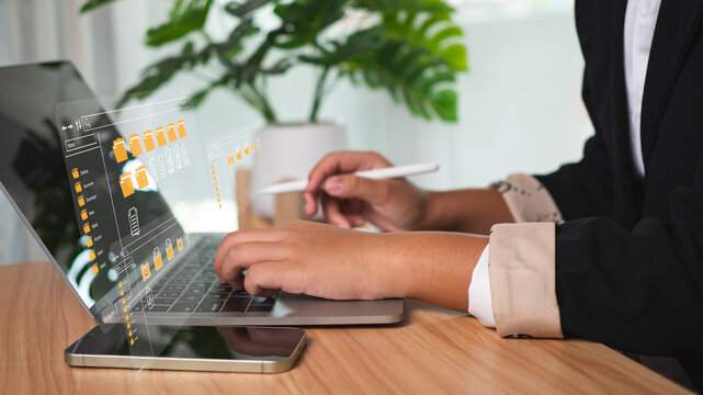 Businesswoman uses computer to manage data with folders and DMS document management system