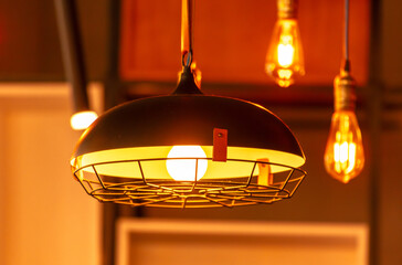 Decorative light bulbs hang on the bar in a cafe