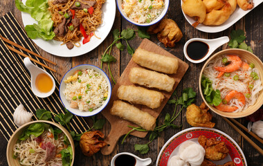 assorted of asian food- stir fry noodles, spring roll, soup, shrimp