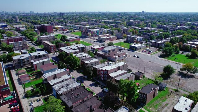 aerial overview of West side suburbs of chicago. Area lived by low income house holders. Poor and dangerous neighbors. West Garfield Park. Semi truck driver driving on the road pulling a white trailer