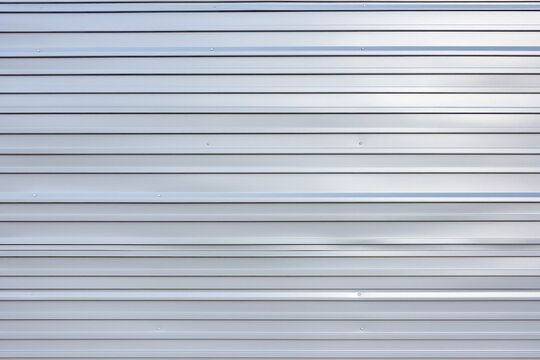 Wall texture of exterior white plastic siding, thin slats, surface material