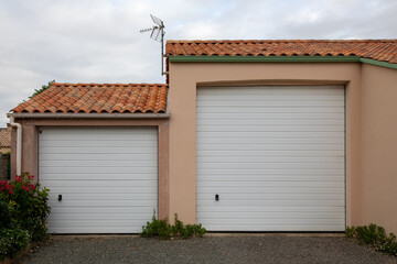 facade high and classic new modern double two garage white on home door of residential house