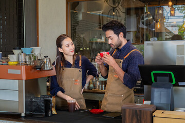 Multicultural couple startup small business bakery cafe restaurant coffee shop wearing apron uniform together partnership, Indian male Asian female barista happy working opening food store teamwork