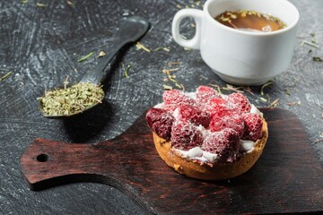 Still life - cake with decoration of sweet strawberries on the table. Green tea - food on a dark background