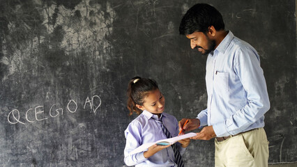 Young male lecturer helping student during his class. Student in a lecture with helpful teacher.