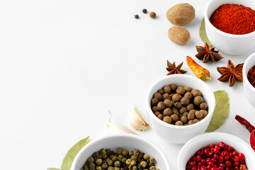 Various spices in a bowls on white background