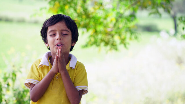 Portrait of Indian School Boy Praying in school ground