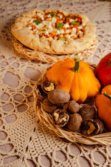 harvest festival with raw pumpkin and homemade galette, pumpkin open pie on table for dinner