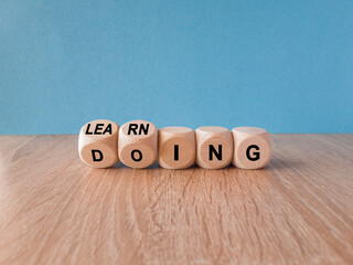 Learning by doing concept. Turned a cube and changes the word learning to doing, or vice versa....