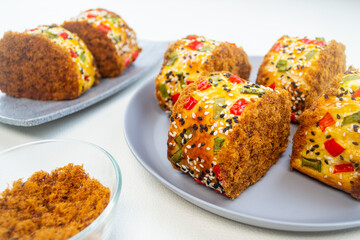 roti gulung abon or floss roll bread. contains shredded meat topped with sesame, spring onions and chili.