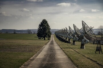 a long road leads into an area with lots of satellite dishes